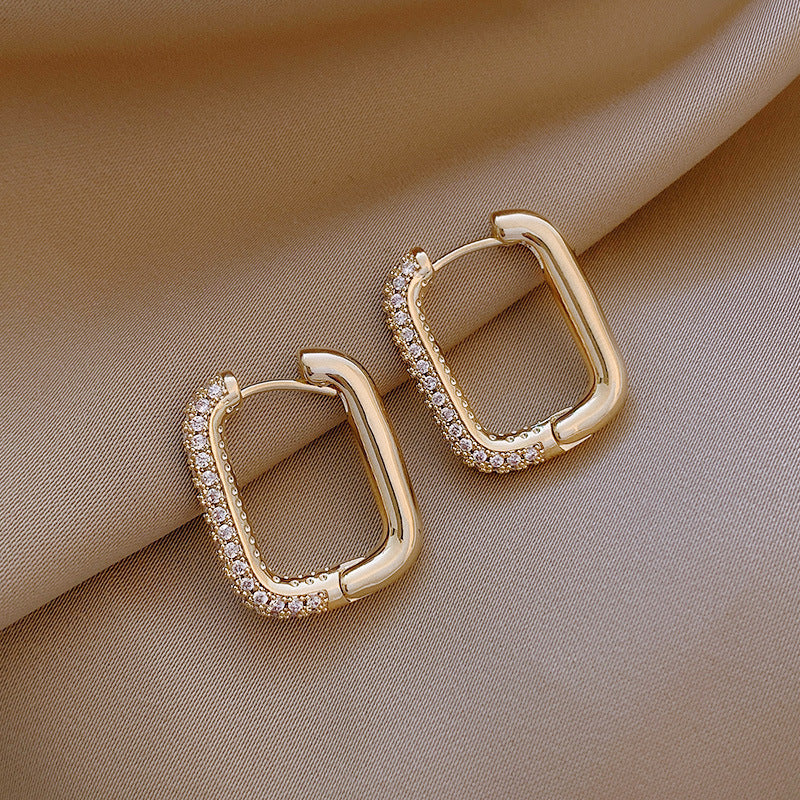Elevate your everyday style with these Geometric Square Zircon Earrings, inspired by minimalism and modern elegance. With a subtle sparkle from zircon stones and a refined square shape, these earrings are the perfect blend of Korean-Japanese fashion and timeless design.